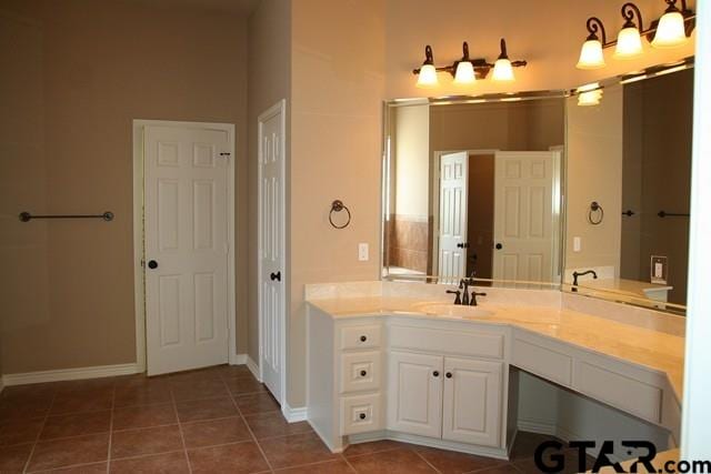 2308 Pinehurst St, Tyler, TX 75703 - bathroom with tile patterned floors, baseboards, and vanity
