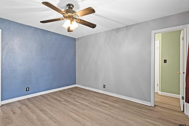 unfurnished room with ceiling fan and light wood-type flooring