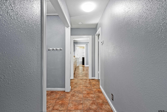 hallway with tile patterned floors