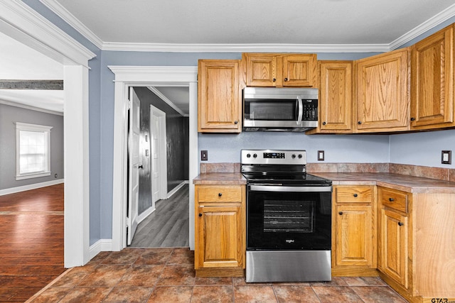 kitchen featuring dark hardwood / wood-style floors, crown molding, and appliances with stainless steel finishes