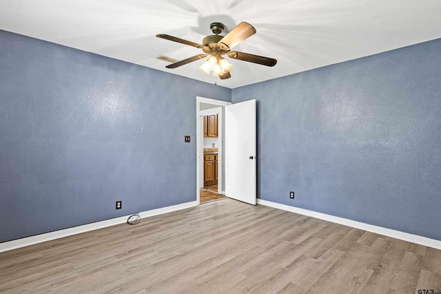 spare room featuring ceiling fan and light wood-type flooring