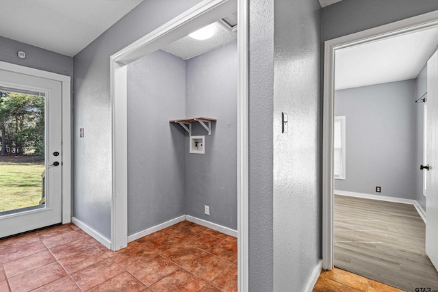 clothes washing area with tile patterned floors and washer hookup