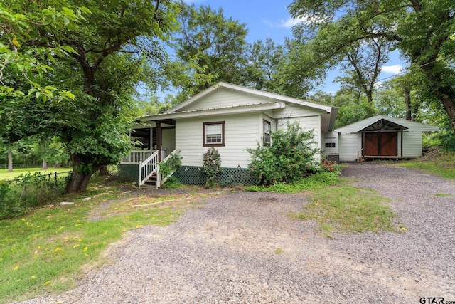 118 Lynn Creek Dr, Mabank, TX 75156 - view of front of property with an outdoor structure, a storage shed, driveway, and covered porch