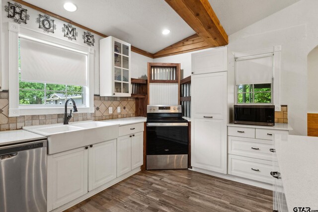 118 Lynn Creek Dr, Mabank, TX 75156 - kitchen featuring appliances with stainless steel finishes, white cabinetry, decorative backsplash, vaulted ceiling with beams, and dark wood-style floors