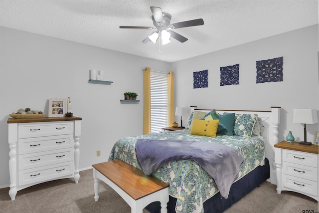 bedroom featuring a textured ceiling, ceiling fan, and carpet