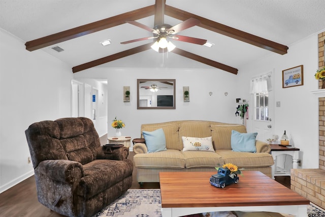 living room featuring hardwood / wood-style flooring, ceiling fan, lofted ceiling with beams, and a fireplace