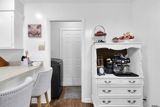 kitchen with white cabinets, dark hardwood / wood-style flooring, and crown molding