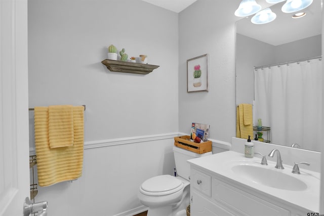 bathroom featuring toilet and vanity