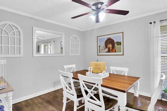 dining area with dark wood-type flooring, a textured ceiling, ceiling fan, and ornamental molding