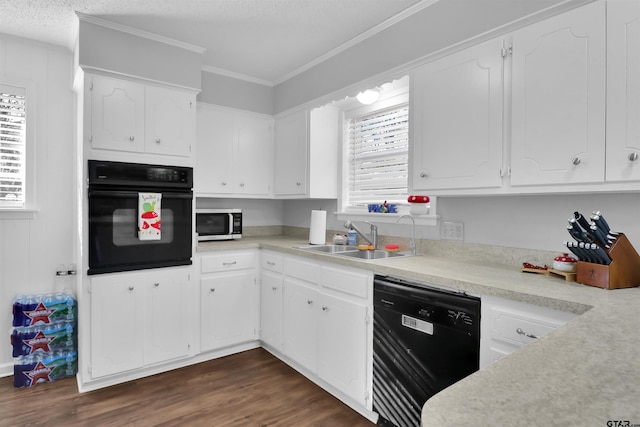 kitchen featuring white cabinets, dark wood-type flooring, black appliances, and sink