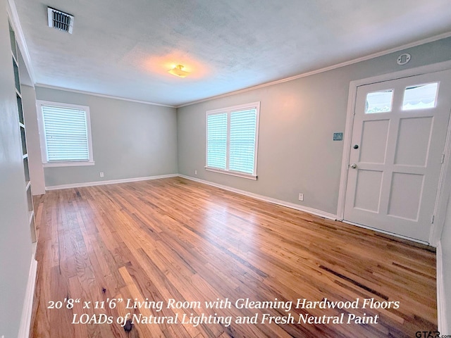 902 W 9th St, Tyler, TX 75701 - entrance foyer with ornamental molding, light wood-type flooring, baseboards, and healthy amount of natural light