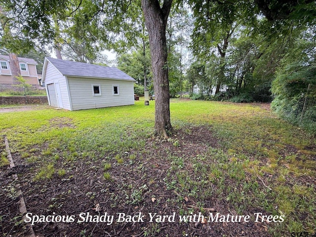 902 W 9th St, Tyler, TX 75701 - view of green lawn with a garage and an outbuilding