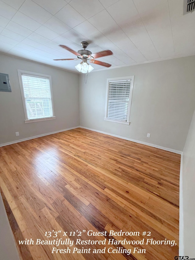 902 W 9th St, Tyler, TX 75701 - empty room featuring wood finished floors, a ceiling fan, baseboards, and electric panel