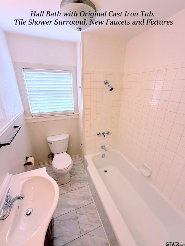 902 W 9th St, Tyler, TX 75701 - bathroom with marble finish floors, toilet, a sink, and  shower combination