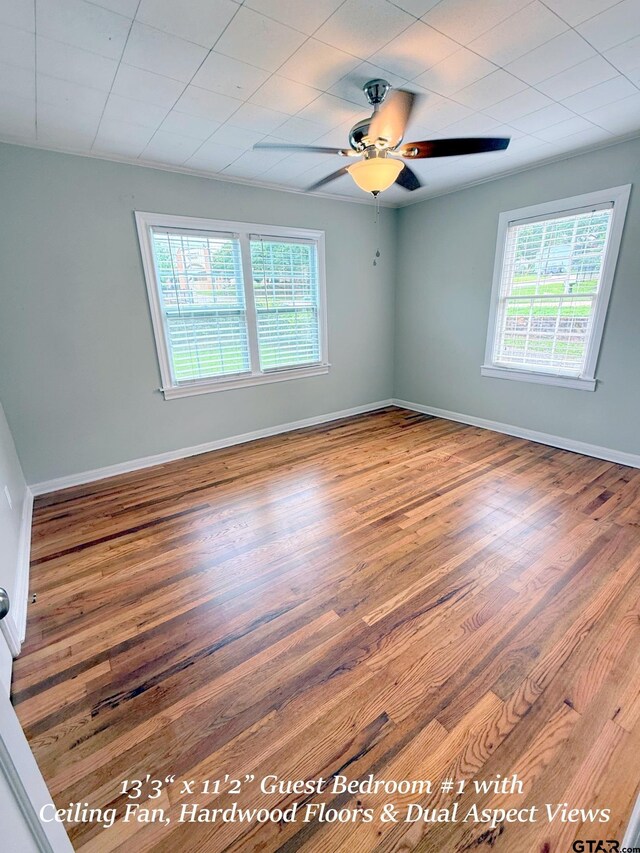 902 W 9th St, Tyler, TX 75701 - unfurnished room with plenty of natural light, wood finished floors, ceiling fan, and baseboards