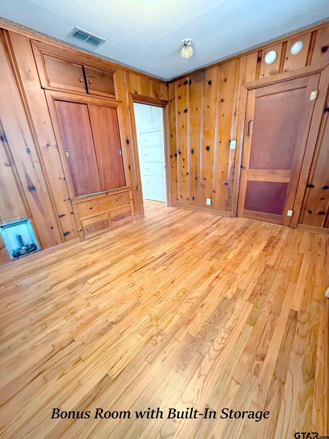 902 W 9th St, Tyler, TX 75701 - unfurnished bedroom featuring wood finished floors and wooden walls