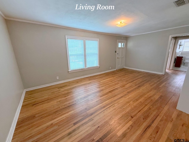 902 W 9th St, Tyler, TX 75701 - spare room featuring crown molding, plenty of natural light, light wood-style floors, and baseboards