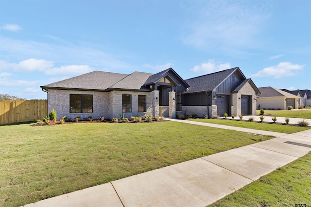 view of front of property with a garage and a front lawn