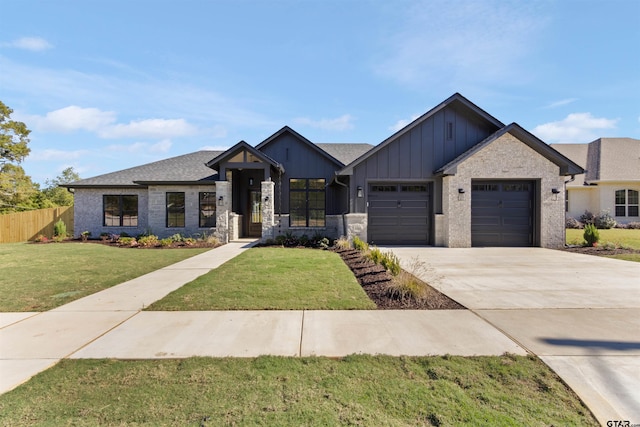 view of front of property featuring a garage and a front lawn