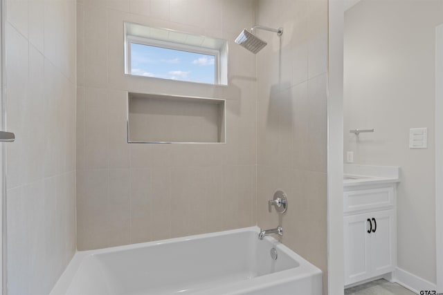 bathroom with vanity and tiled shower / bath