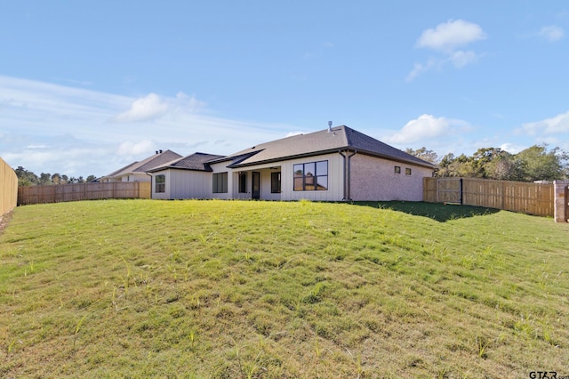 back of house with a yard