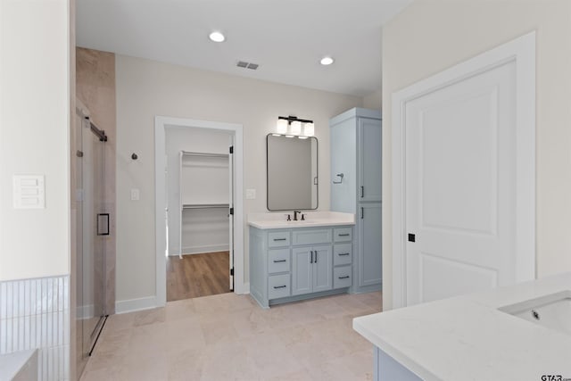 bathroom featuring vanity and walk in shower