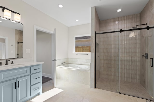 bathroom featuring vanity and independent shower and bath