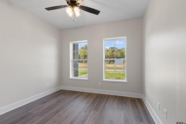 unfurnished room with ceiling fan and dark hardwood / wood-style flooring