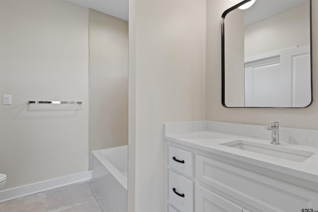 bathroom featuring tile patterned flooring, a bath, vanity, and toilet