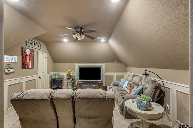 1299 Shadow Lks, Terrell, TX 75160 - home theater with a decorative wall, ceiling fan, vaulted ceiling, a wainscoted wall, and carpet flooring