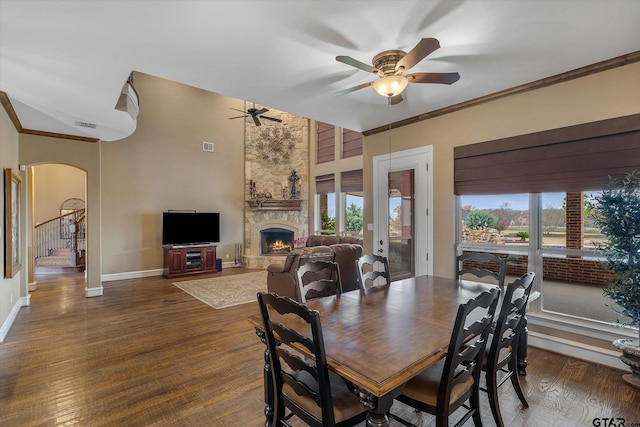 1299 Shadow Lks, Terrell, TX 75160 - dining space featuring arched walkways, ceiling fan, healthy amount of natural light, a fireplace, and ornamental molding