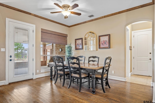1299 Shadow Lks, Terrell, TX 75160 - dining space featuring arched walkways, a ceiling fan, crown molding, and wood finished floors