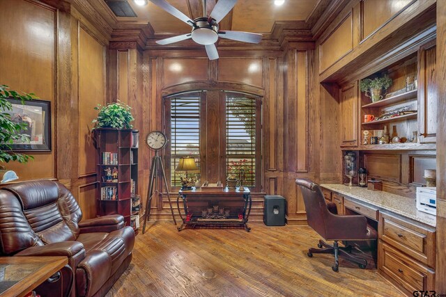 1299 Shadow Lks, Terrell, TX 75160 - office area featuring wooden walls, built in desk, ornamental molding, ceiling fan, and wood finished floors