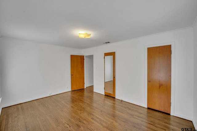 unfurnished room with hardwood / wood-style floors