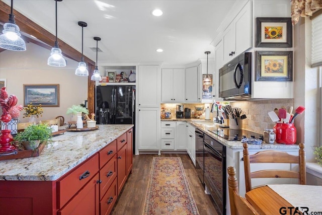 kitchen with hanging light fixtures, dark wood-type flooring, black appliances, sink, and white cabinetry