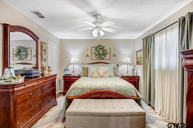 bedroom featuring ceiling fan and a textured ceiling