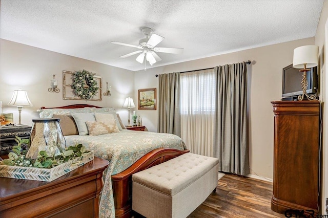 bedroom featuring a textured ceiling, ceiling fan, and dark hardwood / wood-style floors