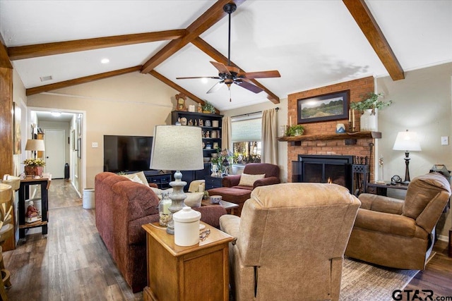 living room featuring a brick fireplace, ceiling fan, vaulted ceiling with beams, and dark hardwood / wood-style floors