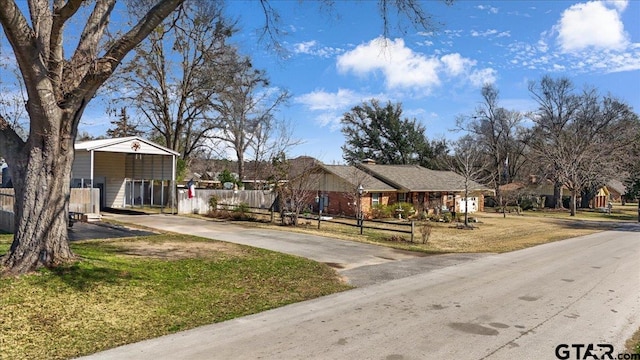 view of front of house featuring a front lawn and a carport