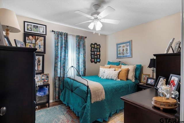 bedroom with a textured ceiling and ceiling fan