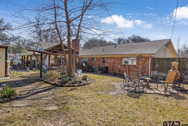 back of property with a lawn and a patio area