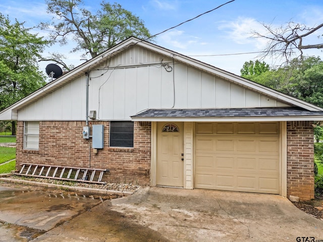 306 Dellwood Dr, Mount Pleasant, TX 75455 - view of front of house with brick siding, a garage, concrete driveway, and board and batten siding