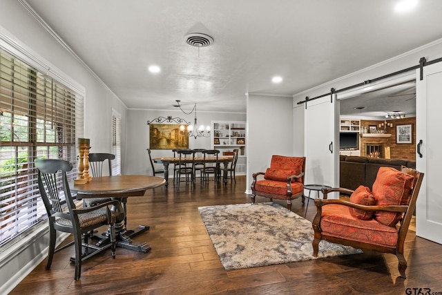 306 Dellwood Dr, Mount Pleasant, TX 75455 - living room featuring a barn door, ornamental molding, wood-type flooring, recessed lighting, and a chandelier