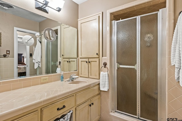 306 Dellwood Dr, Mount Pleasant, TX 75455 - bathroom featuring vanity, ensuite bath, and a stall shower