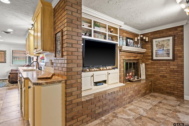306 Dellwood Dr, Mount Pleasant, TX 75455 - living room featuring a textured ceiling, ornamental molding, a fireplace, and stone finish flooring
