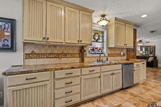 306 Dellwood Dr, Mount Pleasant, TX 75455 - kitchen featuring stainless steel dishwasher, cream cabinetry, a textured ceiling, backsplash, and dark countertops