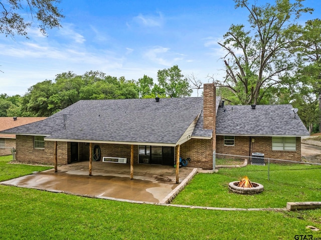306 Dellwood Dr, Mount Pleasant, TX 75455 - rear view of property with a patio area, a fire pit, a chimney, brick siding, and roof with shingles