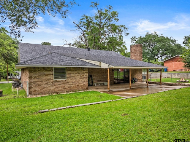 306 Dellwood Dr, Mount Pleasant, TX 75455 - back of house with a patio, roof with shingles, a chimney, and brick siding