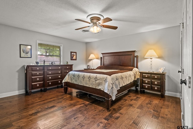 306 Dellwood Dr, Mount Pleasant, TX 75455 - bedroom featuring dark wood-style floors, a textured ceiling, and a ceiling fan