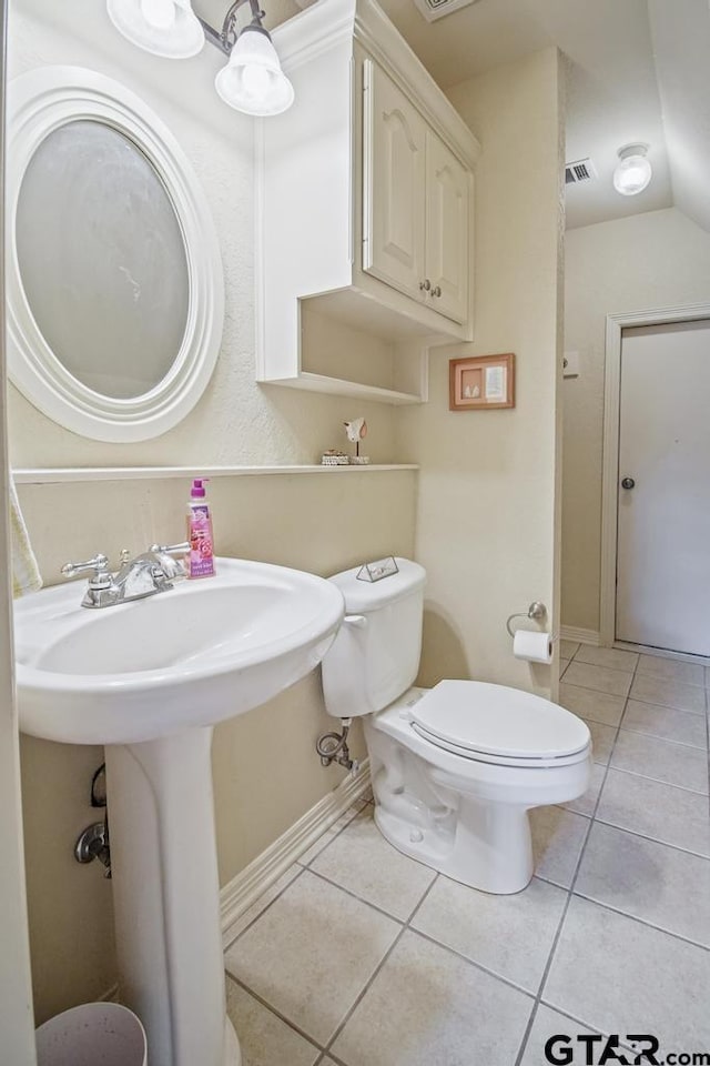 502 Northcreek Dr, Chandler, TX 75758 - bathroom with tile patterned floors, baseboards, toilet, lofted ceiling, and a sink